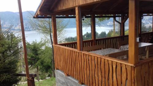 a wooden gazebo with a view of a lake at Casa Edy in Colibiţa