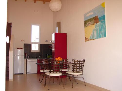 a dining room with a table and chairs in a kitchen at Quinta de Moledos in Aljezur