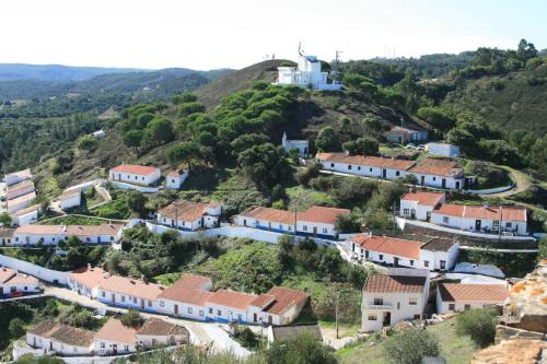 a small village on a hill with a white house at Quinta de Moledos in Aljezur
