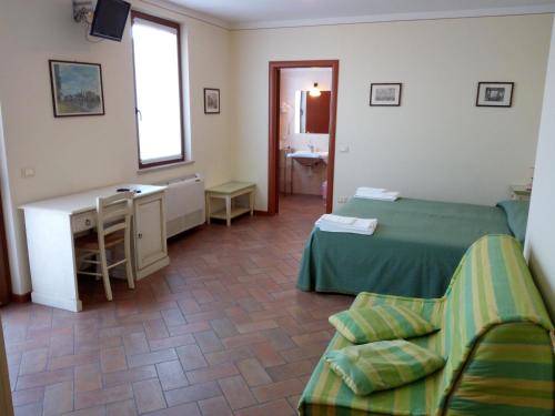 a hotel room with two beds and a desk at BB Mambrotta in San Martino Buon Albergo