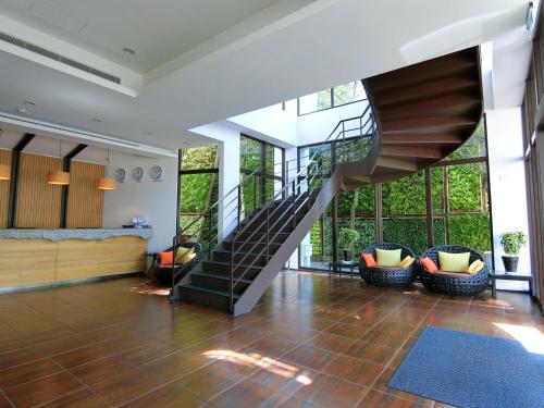 a lobby with a spiral staircase in a house at LeaLea Garden Hotels - Moon Lake in Yuchi