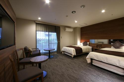 The Hedistar Hotel Narita tesisinde bir odada yatak veya yataklar