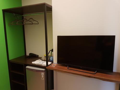 a large flat screen tv sitting on top of a desk at Romeo B&B in Taitung City