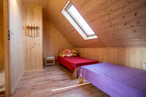 a attic room with two beds and a skylight at Ośrodek Wczasowy Maliwa in Jarosławiec