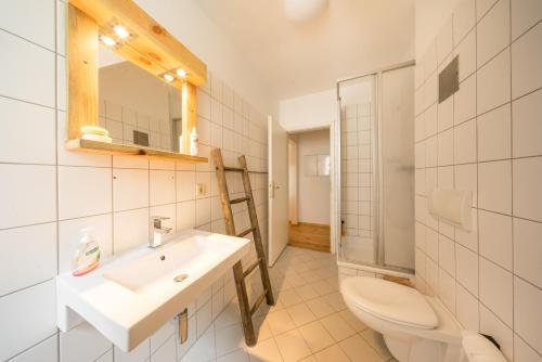 a bathroom with a sink and a toilet and a mirror at Design Apartments - "Am Jägertor" in Potsdam