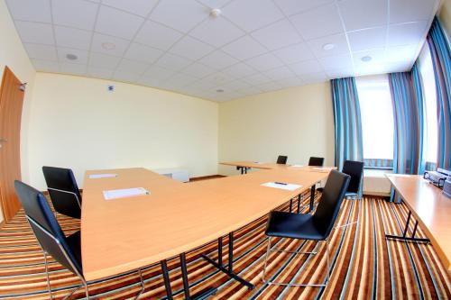 a conference room with a large wooden table and chairs at Auto Port Renice in Myślibórz