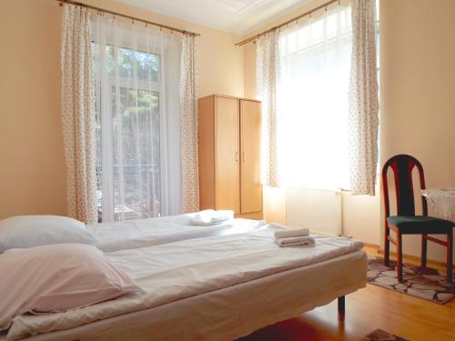 a bedroom with a bed and a large window at Ośrodek Wypoczynkowy Rapsodia in Krynica Zdrój