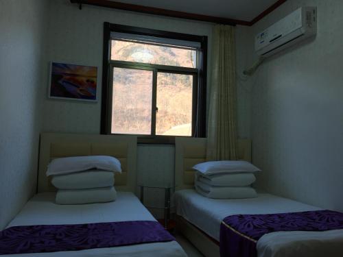 Postel nebo postele na pokoji v ubytování Huangyaguan Great Wall Li Bo Home Hotel