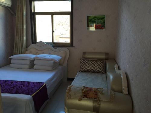 Postel nebo postele na pokoji v ubytování Huangyaguan Great Wall Li Bo Home Hotel