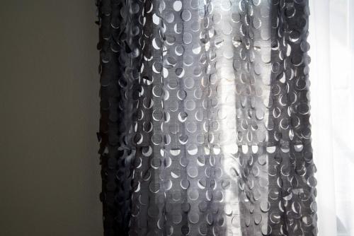 a black and white curtain on a window at Cascina36 B&B in Pregnana Milanese