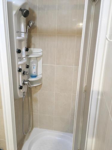 a shower stall in a bathroom with a toilet at Sea Star in Fuengirola