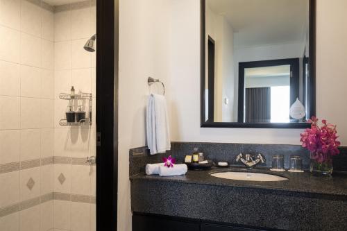 a bathroom with a sink and a mirror at Somerset Vientiane in Vientiane