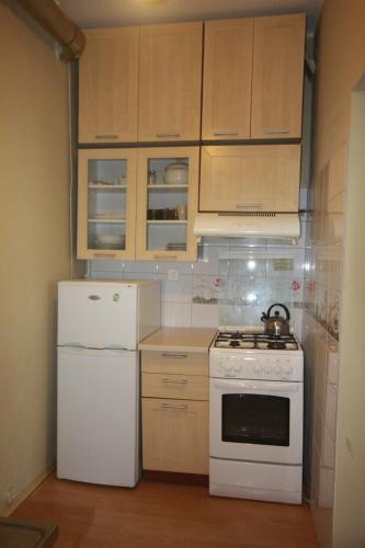 a kitchen with a white stove and a refrigerator at Little studio in Gdańsk in Gdańsk