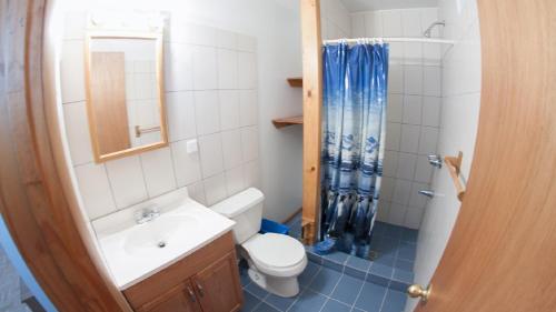 a bathroom with a toilet and a sink and a shower at Ermolaos Hillside Villas in Lixouri
