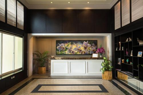 a lobby with a painting on the wall at Somerset Vientiane in Vientiane