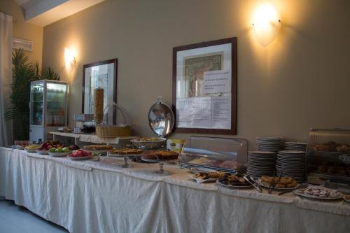 a buffet line with food on a table at Hotel Enrichetta in Desenzano del Garda