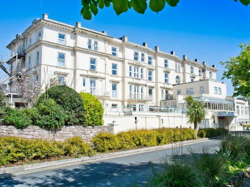 a large white building with a road in front of it at TLH Victoria Hotel - TLH Leisure, Entertainment and Spa Resort in Torquay