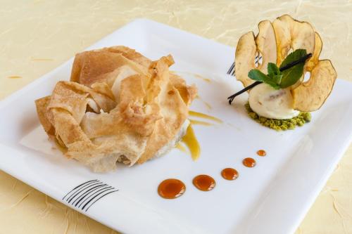 a white plate with some food on it at Hôtel Restaurant du Château in Rocamadour