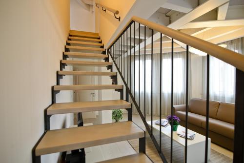 a staircase in a house with wooden stairs and a couch at Residence La Fontaine in Venice-Lido