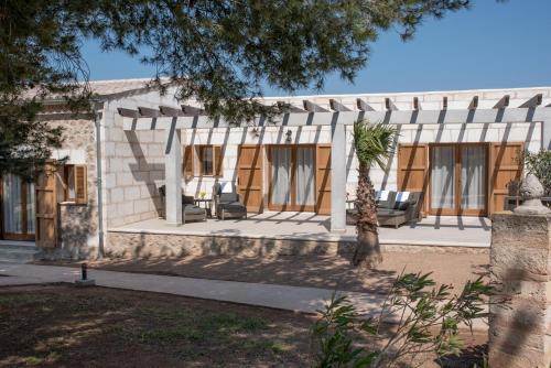 a house with a palm tree in front of it at Casa Font i Roig in Maria de la Salut