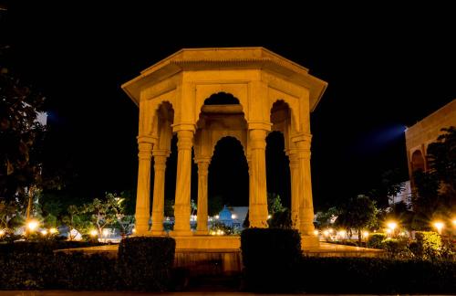 a large monument in a park at night at Pratap Mahal Pushkar IHCL SeleQtion in Pushkar