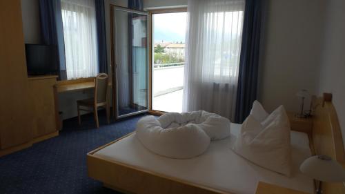 a hotel room with a bed with a white bowl on it at Bad Kochenmoos in Naturno