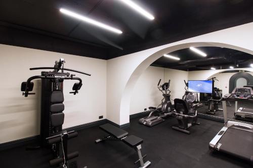 a gym with two treadmills and two ellipticals at La Falconeria Hotel in Valletta