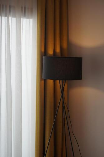 a black lamp in front of a curtain at Rincon 13 - Mares in Torre del Mar