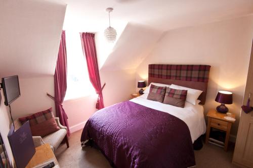 Ένα ή περισσότερα κρεβάτια σε δωμάτιο στο The Ness Guest House