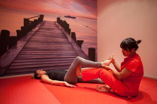 a woman and a baby laying on the floor in front of a staircase at Hotel Bryza Resort & Spa in Jurata