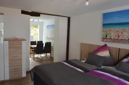 a bedroom with a bed and a table with chairs at Ferienapartments Cafe Stilbruch in Heimbach