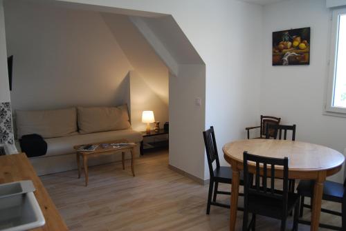 a living room with a table and a couch at Ramier in Giverny