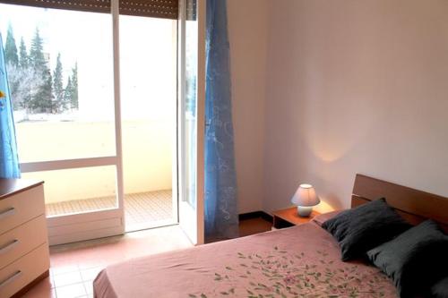 a bedroom with a bed and a large window at Rubino in Gallipoli