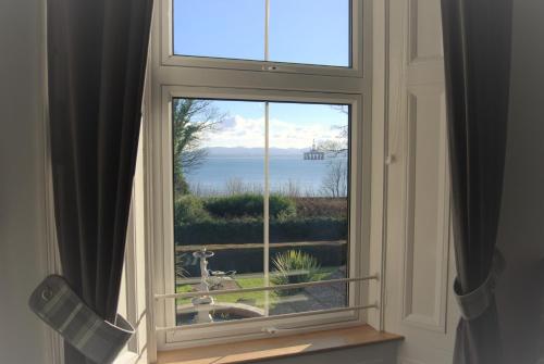 an open window with a view of the water at Kingswood Hotel in Burntisland