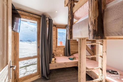 a room with two bunk beds and a window at Nazca C8 in Val Thorens