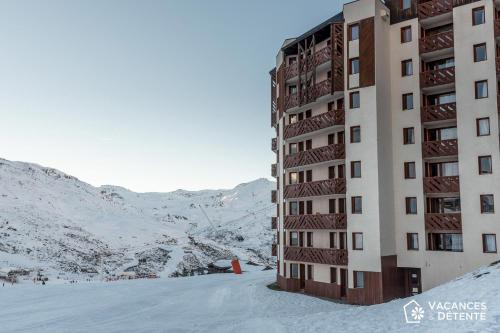 a building on top of a snow covered mountain at Nazca C8 in Val Thorens