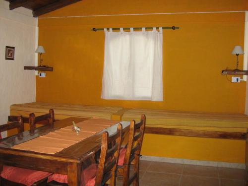 a dining room with a table and a window at Monteverde in La Paz