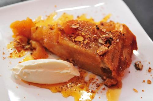 a piece of pie with ice cream on a white plate at SY-la terrasse in Vézelay