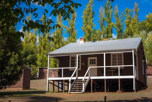 a small house with a porch and a staircase at Lewana Cottages in Balingup