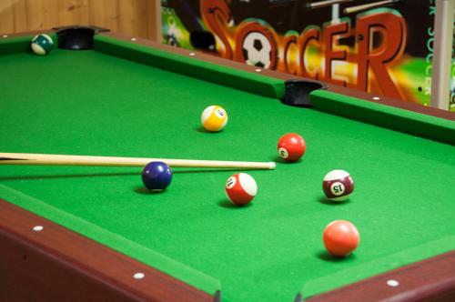 a pool table with balls and cues on it at Arkadenhof Flasch in Wörterberg