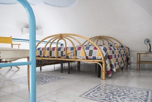 a room with two beds with colorful blankets at Salvatore 6 in Ponza