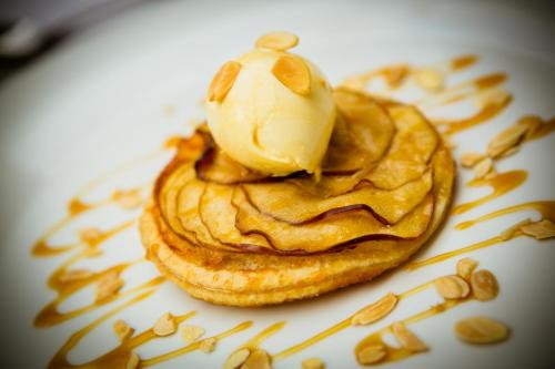 a pastry with ice cream on a plate with nuts at Park Farm Hotel in Norwich