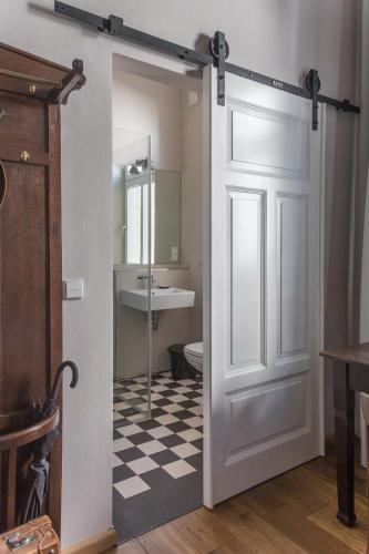 a bathroom with a door and a sink and a toilet at Villa Stern in Oldenburg