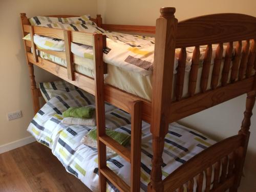 a wooden bunk bed in a room at Greenridge Farmhouse in Crossmaglen