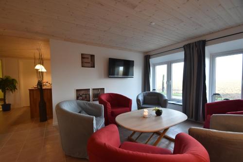 a living room with a table and chairs at Sunset Bed & no Breakfast in Gedser