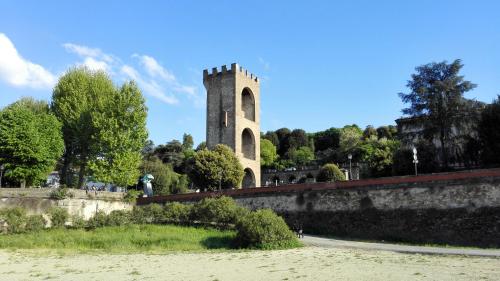 a building with a tower on top of a wall at La Torre in Florence
