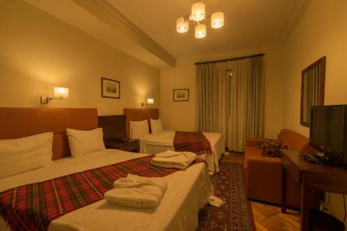 Giường trong phòng chung tại Pao de Acucar Hotel