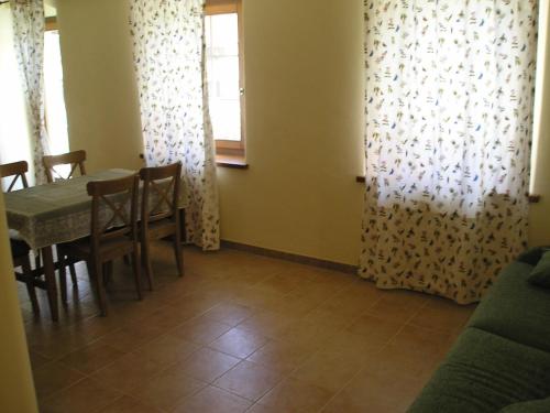 a dining room with a table and chairs and a window at Planavilla in Doues