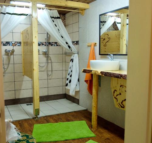 a bathroom with a sink and a shower at Hostel Weisses Rössl in Leutasch
