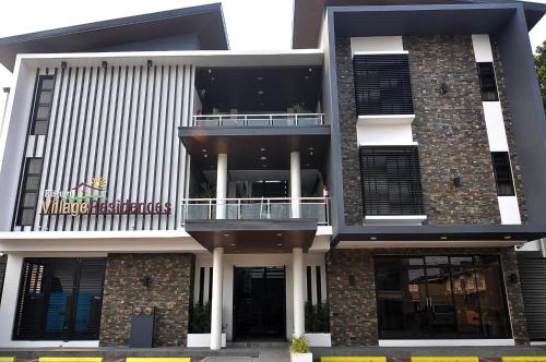 a large white building with a balcony on it at Rishan Village Residences in Angeles